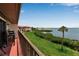 Outdoor balcony featuring lush landscaping and views of the water and nearby grassy areas at 3420 Wild Oak Bay Blvd # 120, Bradenton, FL 34210