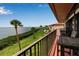 Outdoor balcony featuring lush landscaping, nearby pool, and beautiful views of the water at 3420 Wild Oak Bay Blvd # 120, Bradenton, FL 34210