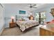 Light-filled bedroom with a sliding glass door and a cozy bed with patterned bedding at 3420 Wild Oak Bay Blvd # 120, Bradenton, FL 34210