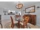Light-filled dining area features a glass table, seating for four, and an open view into kitchen at 3420 Wild Oak Bay Blvd # 120, Bradenton, FL 34210