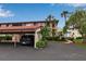 Inviting condominium complex featuring covered parking, palm trees, and well-maintained landscaping at 3420 Wild Oak Bay Blvd # 120, Bradenton, FL 34210
