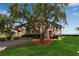 Well-maintained condominium complex with lush landscaping and a beautiful weeping willow tree at 3420 Wild Oak Bay Blvd # 120, Bradenton, FL 34210