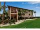 Condominium building surrounded by lush landscaping, featuring private balconies and well-maintained grounds at 3420 Wild Oak Bay Blvd # 120, Bradenton, FL 34210