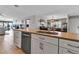 Modern kitchen with a breakfast bar flows into dining area and living spaces with beautiful tile floors at 3420 Wild Oak Bay Blvd # 120, Bradenton, FL 34210