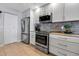Stylish kitchen with stainless steel appliances, modern cabinetry, and tile flooring for easy maintenance at 3420 Wild Oak Bay Blvd # 120, Bradenton, FL 34210