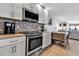 Modern kitchen features stainless steel appliances, updated cabinets, and sleek countertops, open to the living area at 3420 Wild Oak Bay Blvd # 120, Bradenton, FL 34210
