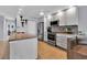 Modern kitchen with white cabinets, stainless steel appliances, and a convenient breakfast bar seating area at 3420 Wild Oak Bay Blvd # 120, Bradenton, FL 34210