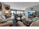 Well-lit living room offering tile floors, comfortable seating options, and easy access to a balcony with scenic views at 3420 Wild Oak Bay Blvd # 120, Bradenton, FL 34210