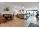 Spacious open-concept living room with tile flooring, a ceiling fan, and access to a patio with natural light at 3420 Wild Oak Bay Blvd # 120, Bradenton, FL 34210