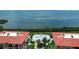 Aerial view of community pool and hot tub surrounded by condos and lush greenery near the waterfront at 3420 Wild Oak Bay Blvd # 120, Bradenton, FL 34210