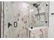 A modern shower features marble walls and glass door at 3420 Wild Oak Bay Blvd # 120, Bradenton, FL 34210