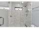 Close-up of the luxurious tile shower with updated fixtures in the renovated bathroom at 3420 Wild Oak Bay Blvd # 120, Bradenton, FL 34210