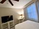Bedroom featuring a neatly made bed, a TV on a stand, and bright natural light from the window at 3506 54Th W Dr # 103, Bradenton, FL 34210