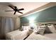 Bright bedroom featuring two beds with white linens, decorative pillows, and a ceiling fan at 3506 54Th W Dr # 103, Bradenton, FL 34210