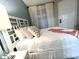 Comfortable bedroom with neutral tones, a white headboard, and natural light at 3506 54Th W Dr # 103, Bradenton, FL 34210