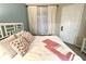 Well-lit bedroom with comfortable linens, flamingo accent pillows, and natural light from a window at 3506 54Th W Dr # 103, Bradenton, FL 34210