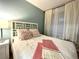 Inviting bedroom with a decorative headboard, soft linens, and large windows at 3506 54Th W Dr # 103, Bradenton, FL 34210