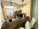 Contemporary kitchen featuring granite countertops, stainless appliances, and breakfast bar at 3506 54Th W Dr # 103, Bradenton, FL 34210