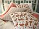 Detailed close-up of stylish throw pillows adorning a neatly made bed with white linens at 3506 54Th W Dr # 103, Bradenton, FL 34210