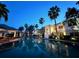 Community pool area with palm trees and a glimpse of surrounding buildings at 3506 54Th W Dr # 103, Bradenton, FL 34210