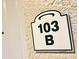 Close-up of unit 103 B sign on the building's exterior at 3506 54Th W Dr # 103, Bradenton, FL 34210