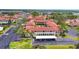 A beautiful aerial view of a condo community with red tile roofs, lush landscaping and close proximity to local amenities at 3690 Pinecrest St # 114, Sarasota, FL 34232