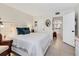 Bright bedroom with tile floors, white bed, and attached bathroom at 3690 Pinecrest St # 114, Sarasota, FL 34232