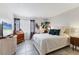 Bright bedroom with tile floors, white bed, and views to the outside at 3690 Pinecrest St # 114, Sarasota, FL 34232