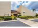 Exterior view of a community center with signage for bingo, surrounded by manicured landscaping and a walkway at 3690 Pinecrest St # 114, Sarasota, FL 34232
