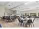 Large common area with tables and chairs, offering residents a versatile space for gatherings and activities at 3690 Pinecrest St # 114, Sarasota, FL 34232