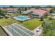 Aerial view of the community pool, shuffleboard courts and manicured lawn space at 3690 Pinecrest St # 114, Sarasota, FL 34232