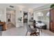 Dining room features a glass table, grey chairs, tile flooring, and built in bar in open concept at 3690 Pinecrest St # 114, Sarasota, FL 34232