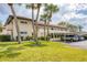 A well-maintained condo complex featuring covered parking, mature palm trees, and lush landscaping at 3690 Pinecrest St # 114, Sarasota, FL 34232