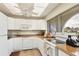 Bright kitchen featuring white cabinets, wood countertops, and modern appliances, offering a functional space at 3690 Pinecrest St # 114, Sarasota, FL 34232