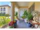 Relaxing lanai area with comfortable seating surrounded by lush greenery, perfect for enjoying the outdoors at 3690 Pinecrest St # 114, Sarasota, FL 34232