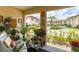 View of the community fountain from the sunny lanai, which is filled with plants and decorated for outdoor living at 3690 Pinecrest St # 114, Sarasota, FL 34232