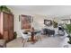 Living room features a glass table, grey chairs, tile flooring, and bright natural light at 3690 Pinecrest St # 114, Sarasota, FL 34232