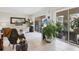 Bright living room featuring neutral tile floors, white couch, and sliding glass doors leading to outdoor patio at 3690 Pinecrest St # 114, Sarasota, FL 34232