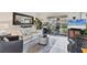 Cozy living room featuring neutral tile floors, white couch, gray accent chair and outdoor patio at 3690 Pinecrest St # 114, Sarasota, FL 34232
