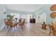 Cozy lounge area featuring wicker furniture, a piano, and large windows, creating a welcoming atmosphere for residents at 3690 Pinecrest St # 114, Sarasota, FL 34232