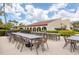 Community patio area with multiple picnic tables and chairs, ideal for outdoor dining and gatherings at 3690 Pinecrest St # 114, Sarasota, FL 34232