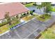 Aerial shot of tennis court adjacent to a building with archways, showcasing the community's recreational amenities at 3690 Pinecrest St # 114, Sarasota, FL 34232