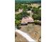 Aerial view of the house, set amid lush greenery and open spaces under a sunny sky at 3717 Downer Ave, Sarasota, FL 34240