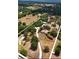 Expansive aerial view of a private estate, featuring a large property, ponds, and surrounded by trees at 3717 Downer Ave, Sarasota, FL 34240