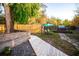 This backyard features a deck, hot tub, privacy fence, and mature trees at 3717 Downer Ave, Sarasota, FL 34240