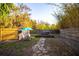 Landscaped backyard featuring a stone walkway, hot tub, lounge chairs, and an umbrella at 3717 Downer Ave, Sarasota, FL 34240