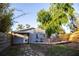 Charming backyard cottage with a wooden deck, stone path, and mature landscaping at 3717 Downer Ave, Sarasota, FL 34240