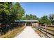 Exterior view of the barn showing its construction and the surrounding gravel driveway at 3717 Downer Ave, Sarasota, FL 34240