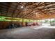 Open barn interior featuring tractor, kayak, overhead lighting, and ample storage space at 3717 Downer Ave, Sarasota, FL 34240