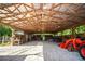 Barn interior featuring a tractor, work benches, overhead lighting, and open design at 3717 Downer Ave, Sarasota, FL 34240